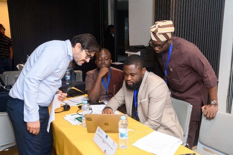 Partners sitting together during a workshop and looking at a laptop.