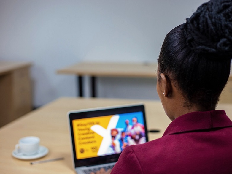 A person looking at a laptop screen.