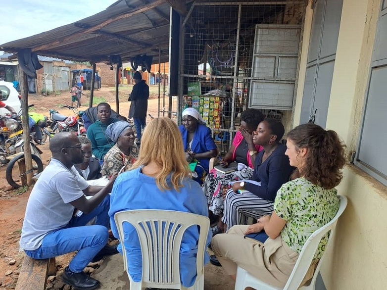 A group of people seated in a circle engaged in discussion.