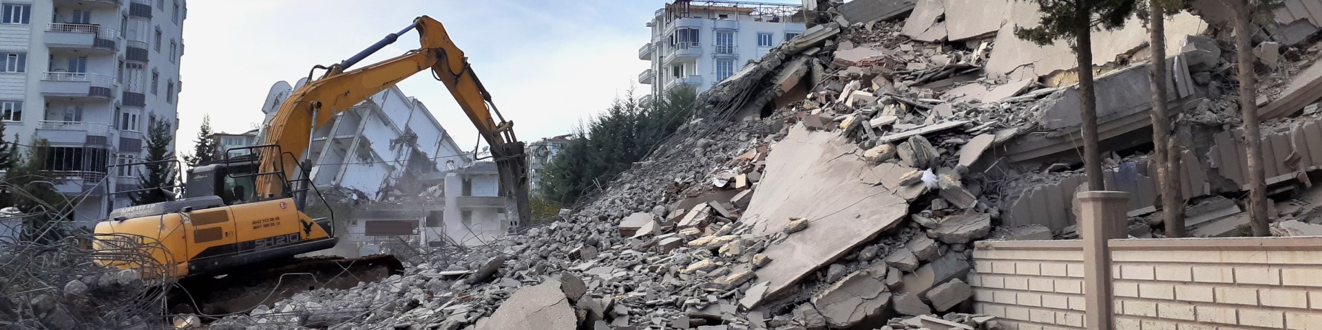 Bulldozer tears down building.