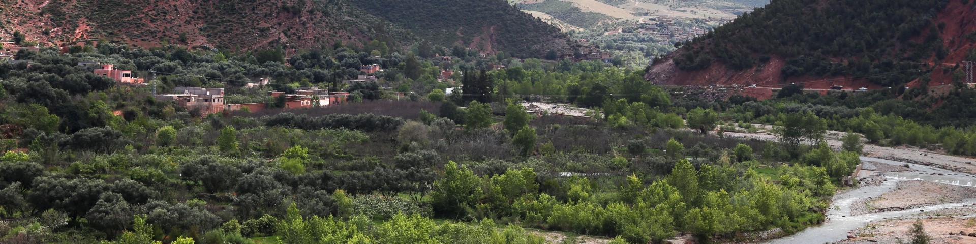 A creek is making its way through a mountainous landscape.