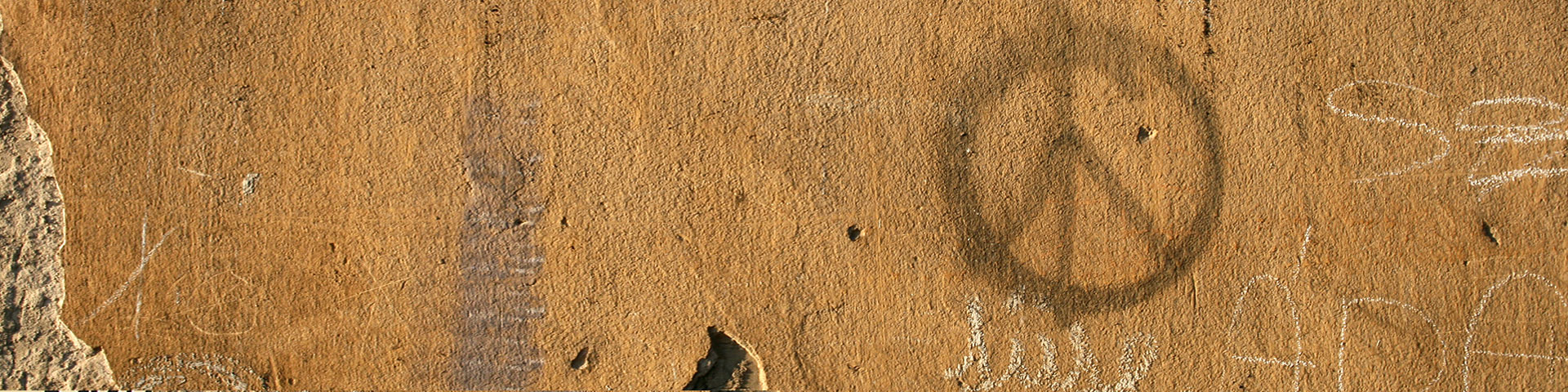 A peace sign on a house wall.