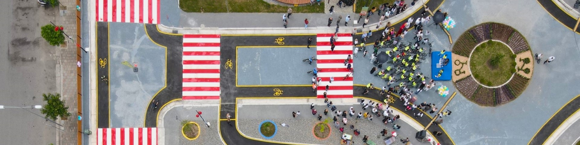 Aerial view of a cycling school near Air Albania Stadium in Tirana, featuring pedestrian crossings and infrastructure improvements, inviting kids to learn safe cycling in the city.