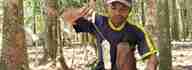 Farmer Tugiman harvests natural rubber.