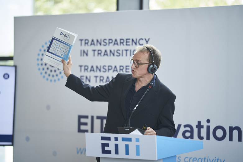 A D-EITI multi-stakeholder group member stands at a podium at the EITI Global Conference in Dakar, Senegal.