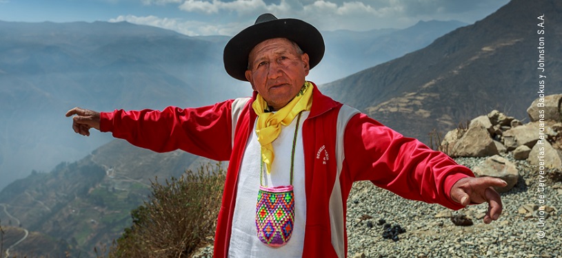 A man points at underground water in the Andes.